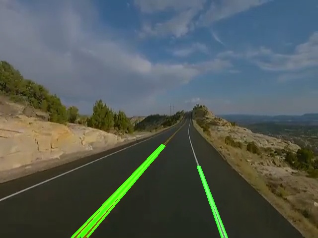 Mountain road with detected lane lines overlaid in bright green, extending from the bottom of the frame toward the vanishing point